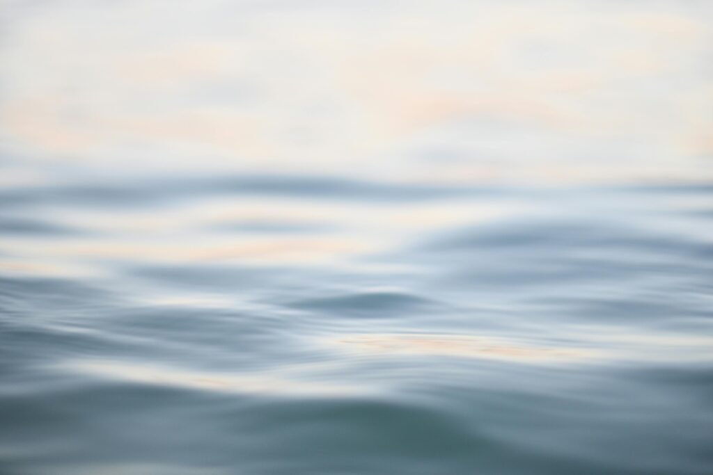 Calming image of serene ocean waves with a gentle blur, perfect for meditation or relaxation themes.
